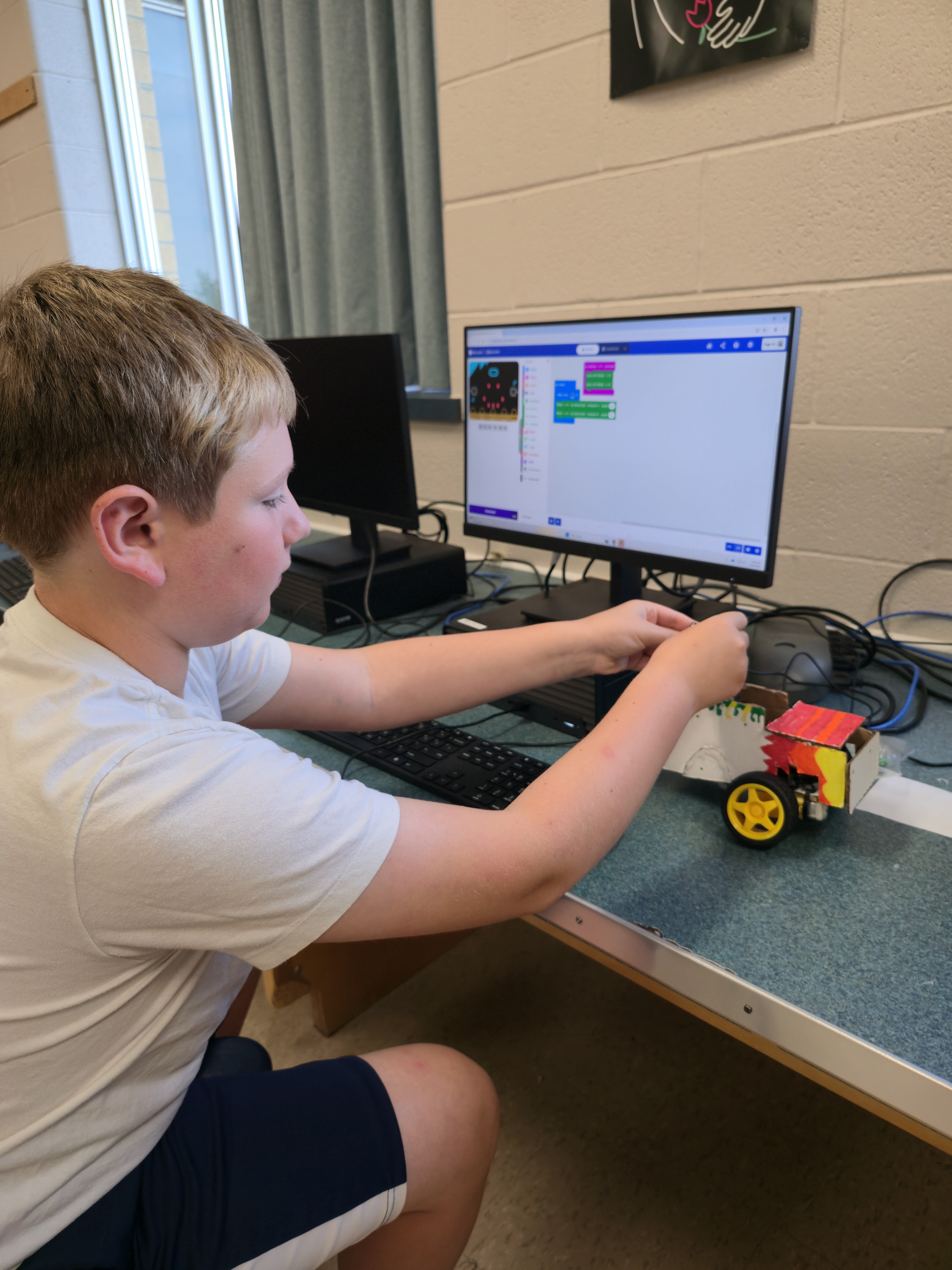 Sum Exp 1 Student seated by a computer in the Summer Expedition program
