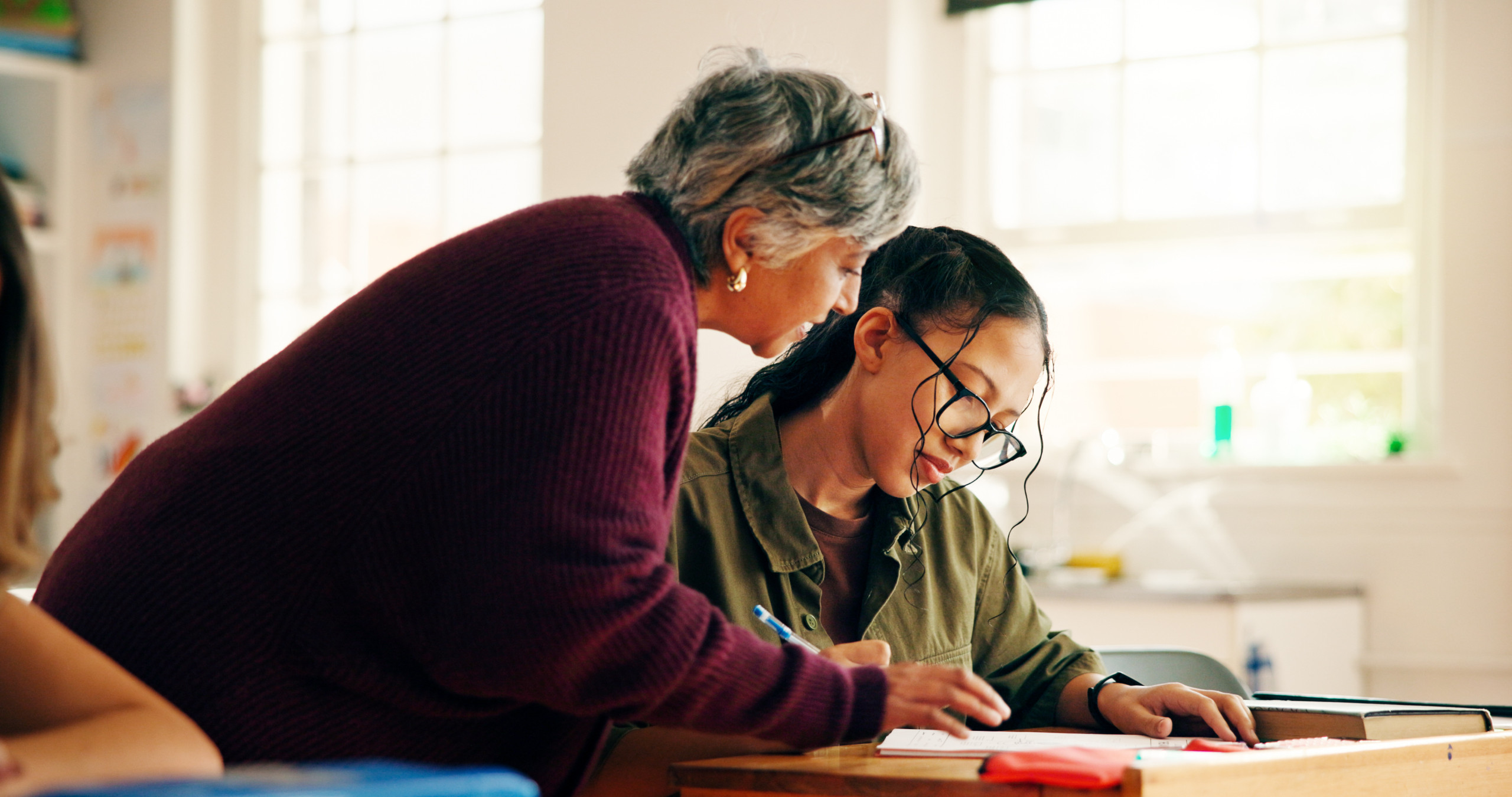 A teacher providing assistance to a student