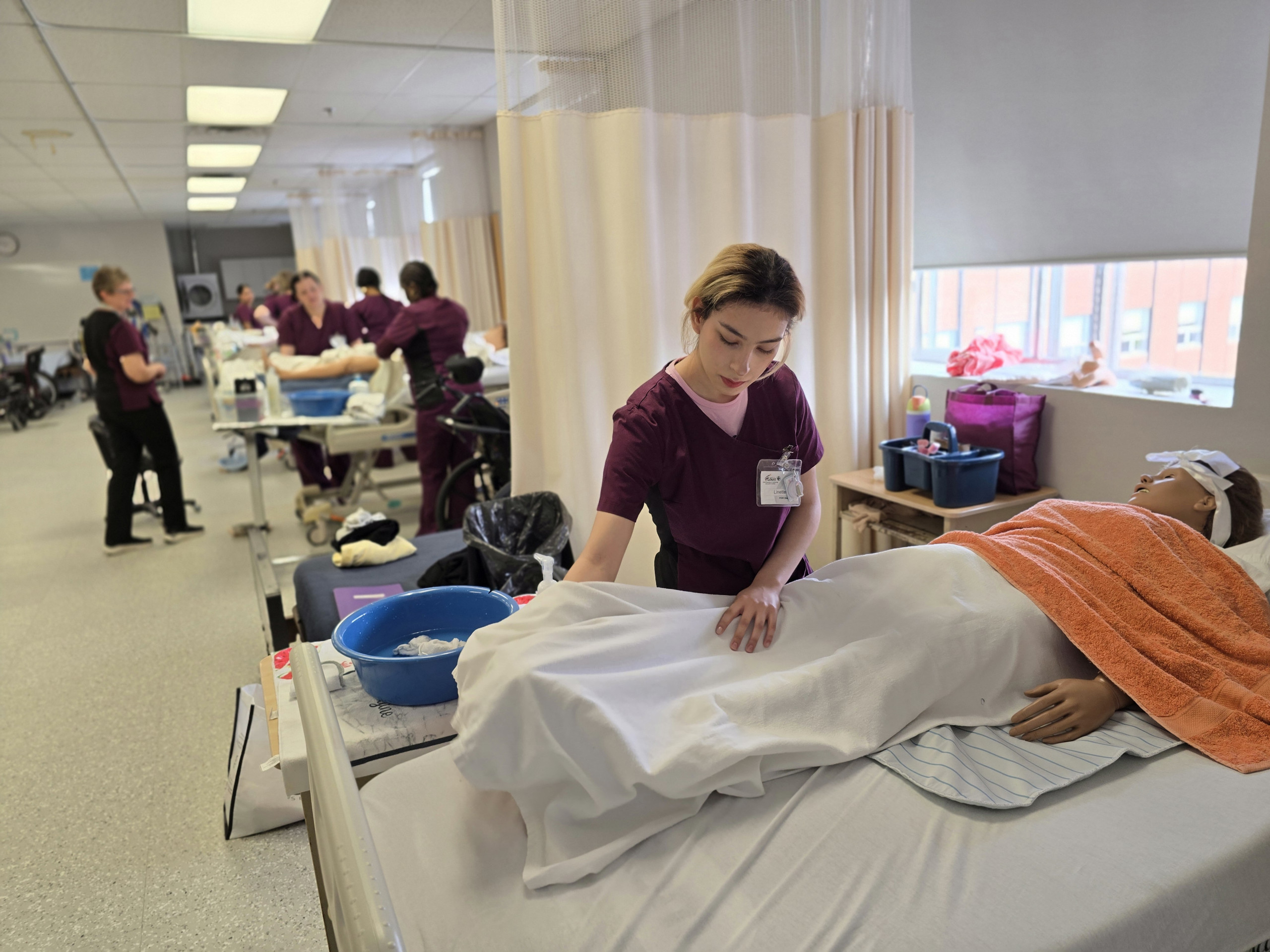 Student Training in the PSW Program A student practicing at a bedside in the PSW Program at St. Louis