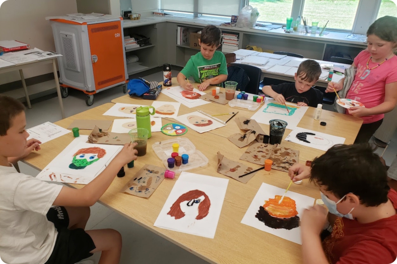 Students painting pictures in the classroom Students painting pictures in the classroom